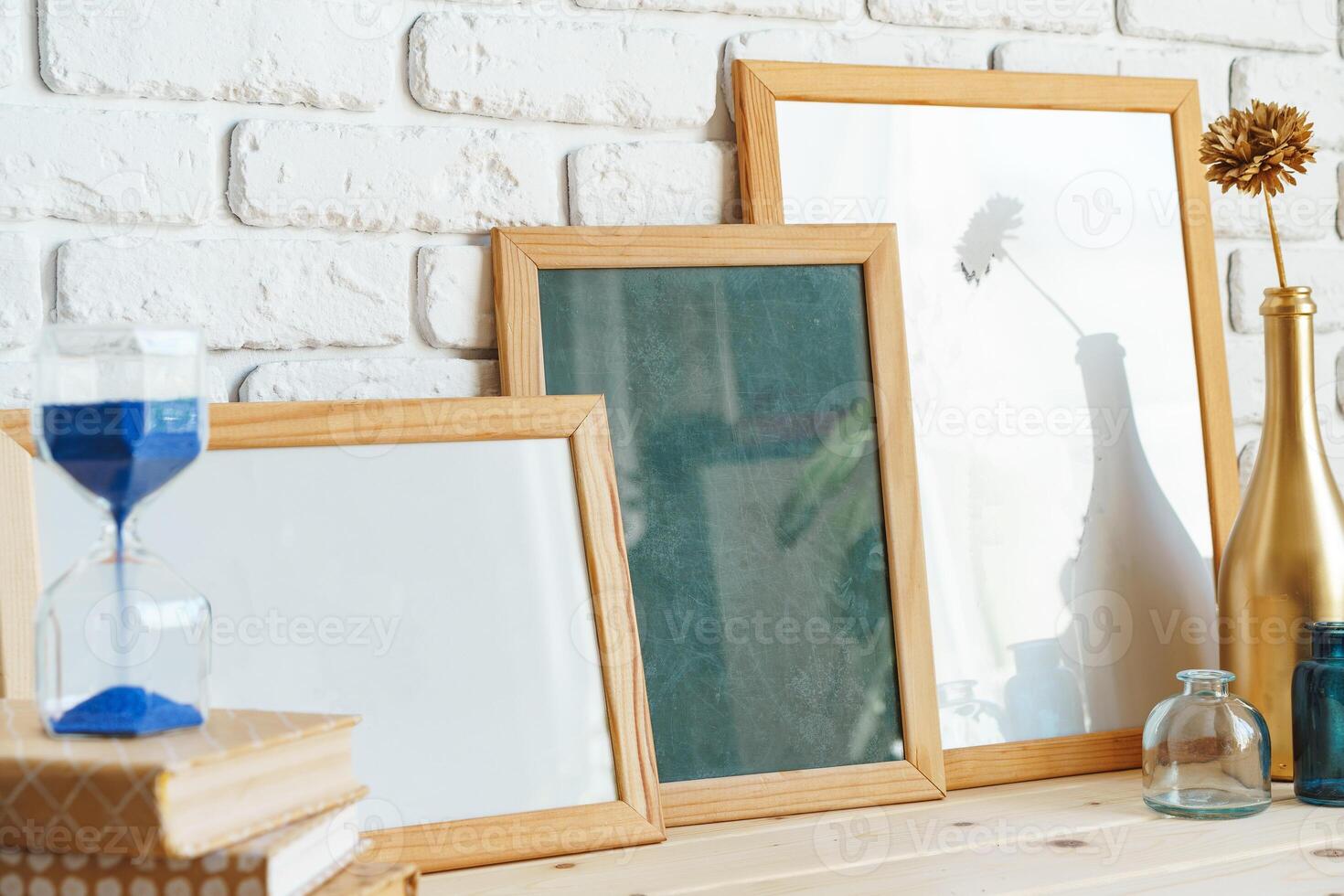 Wooden frame mockup on table with modern vase and books photo