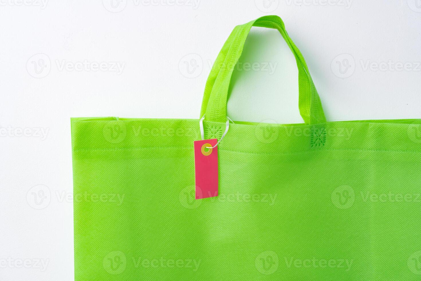 Blank paper tag with shopper paperbag on white background photo