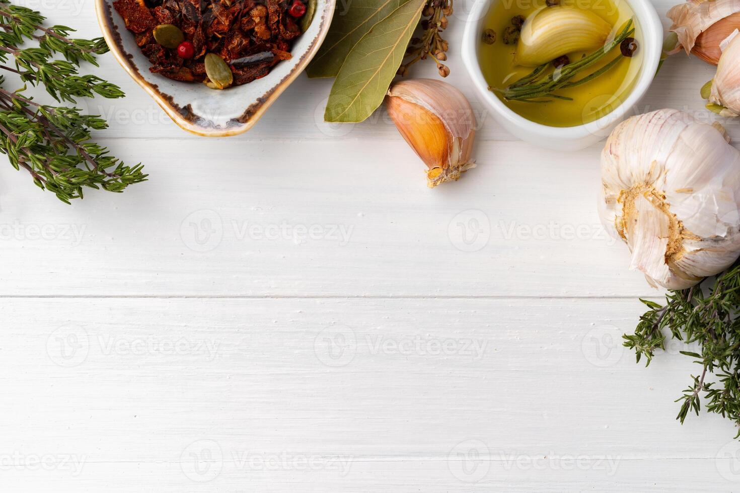 Olive oil and spices on kitchen table photo
