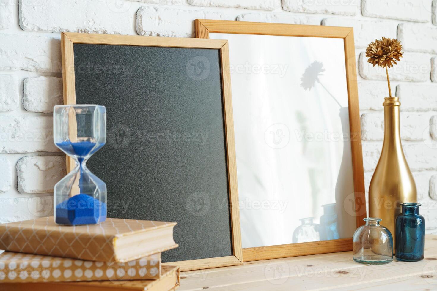 Wooden frame mockup on table with modern vase and books photo