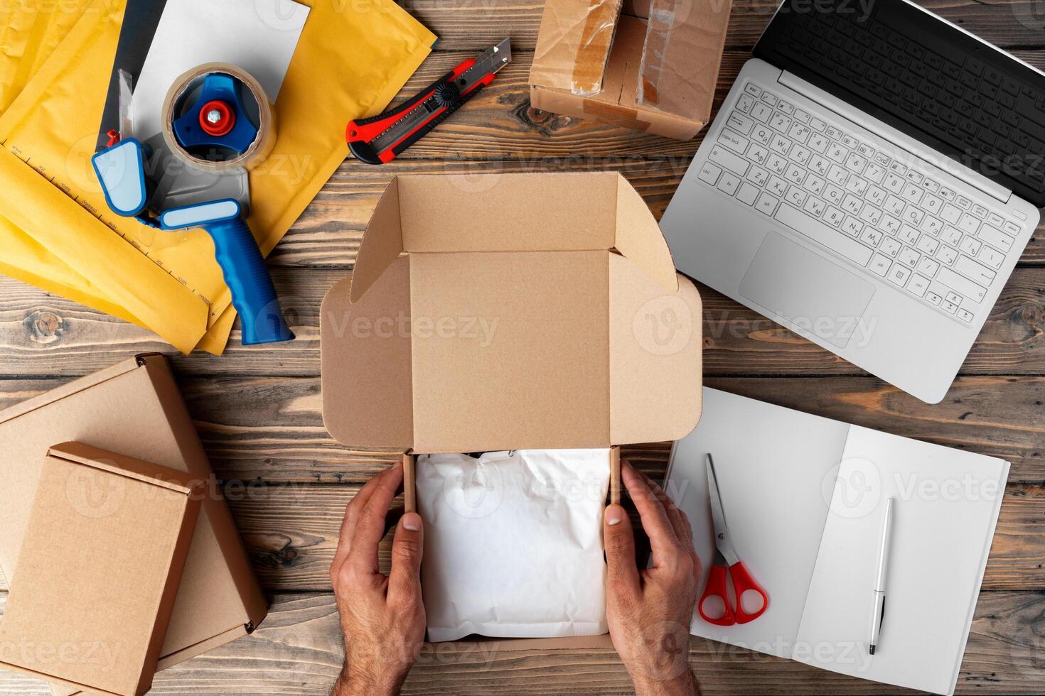 Packing products for delivery on wooden table, top view photo