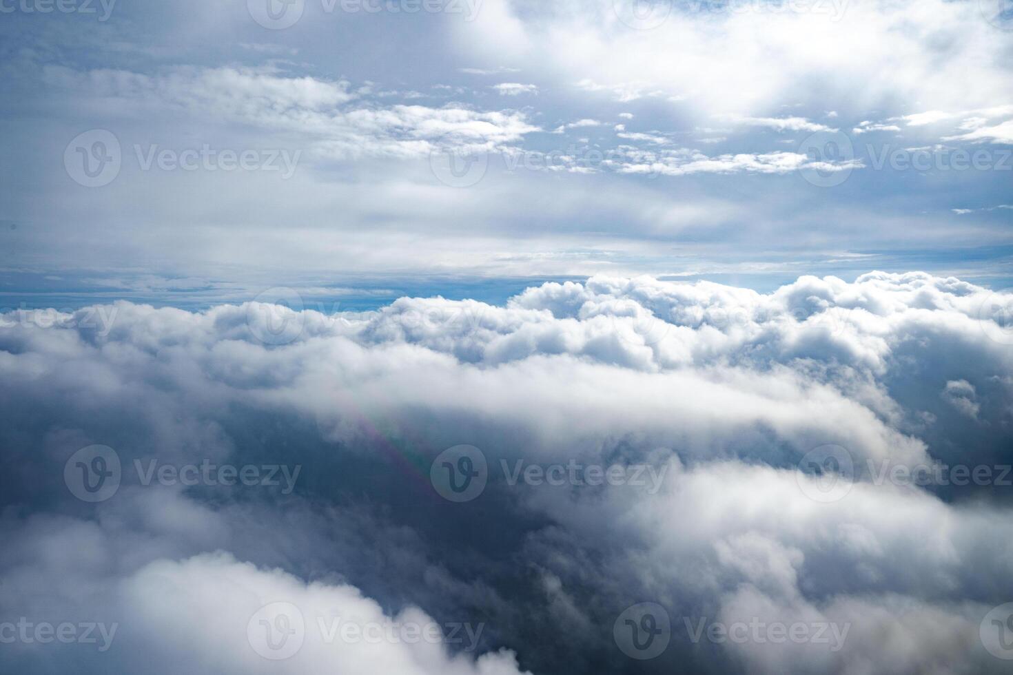 Clouds and aerial view as seen in window of an aircraft photo
