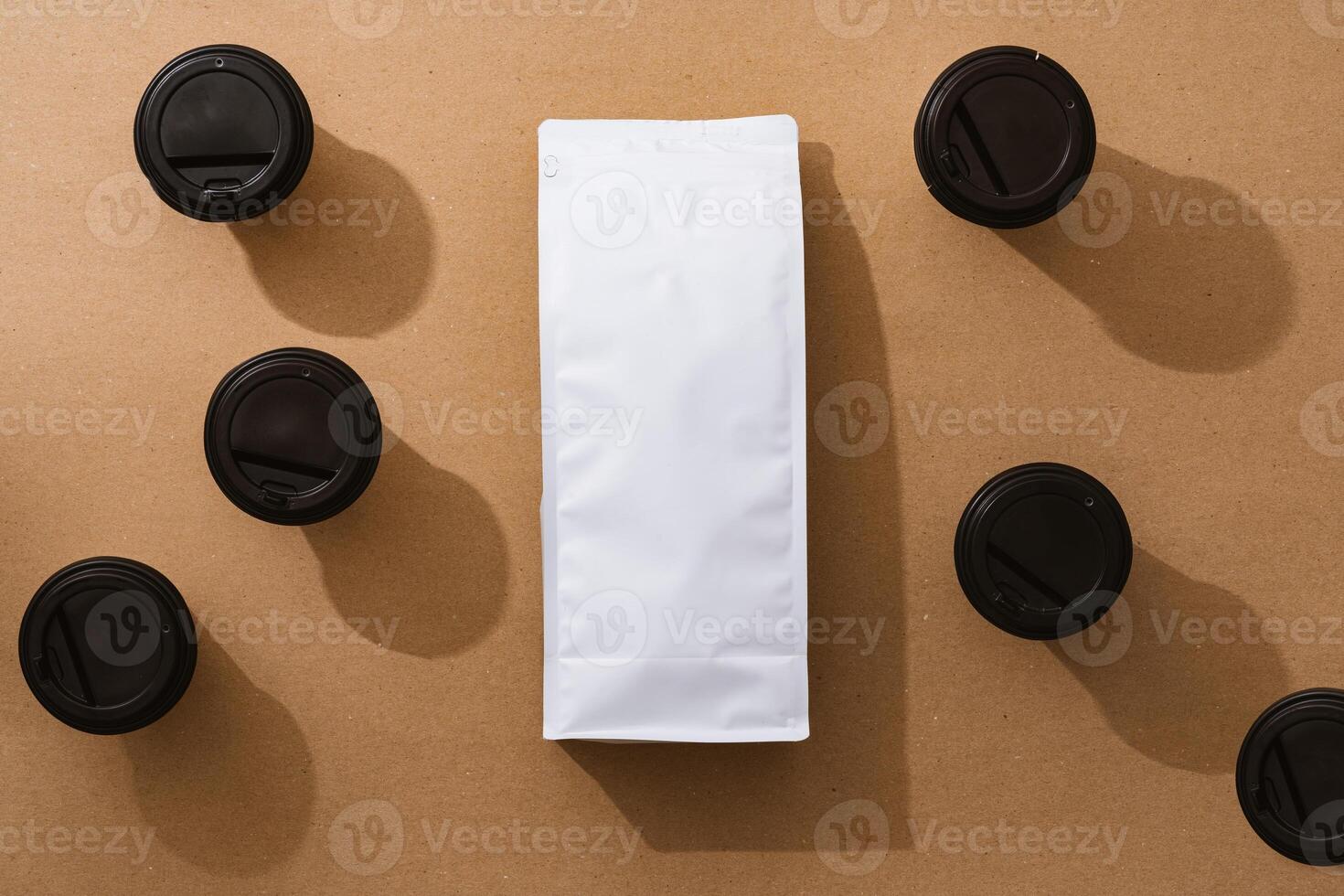 Blank coffee package with copy space and takeout cups on beige background photo