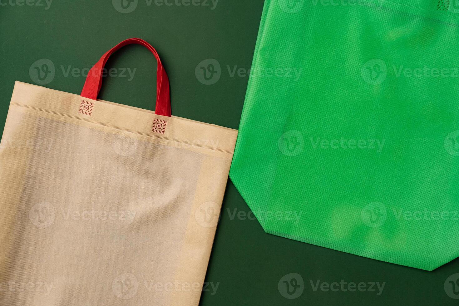 Textile shopping bag on green background flat lay photo