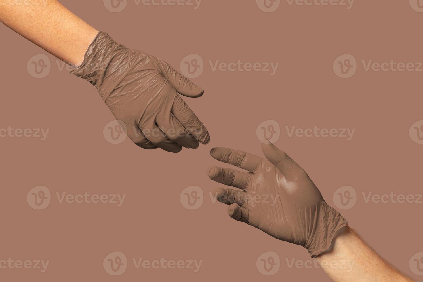 Hands in brown gloves exchanging an object against a neutral background, symbolizing cooperation and assistance photo