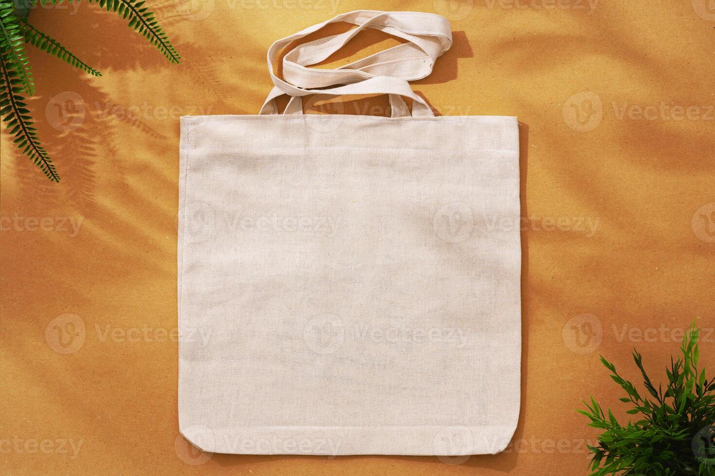 Textile shopping bag on beige background flat lay photo