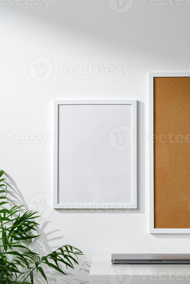 Cork board and blank frame hanging on the wall photo