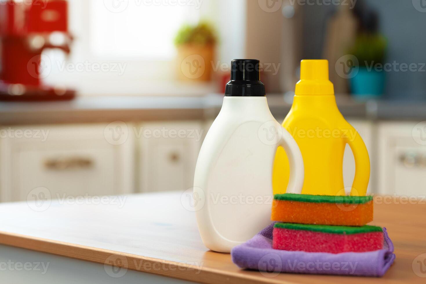 Cleaning detergents and tools on a kitchen counter photo