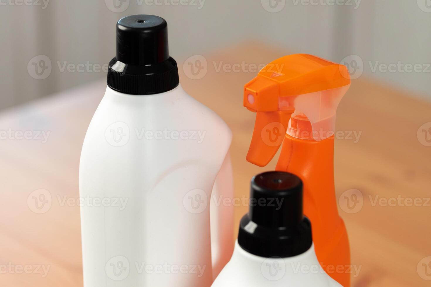 Cleaning detergents and tools on a kitchen counter photo