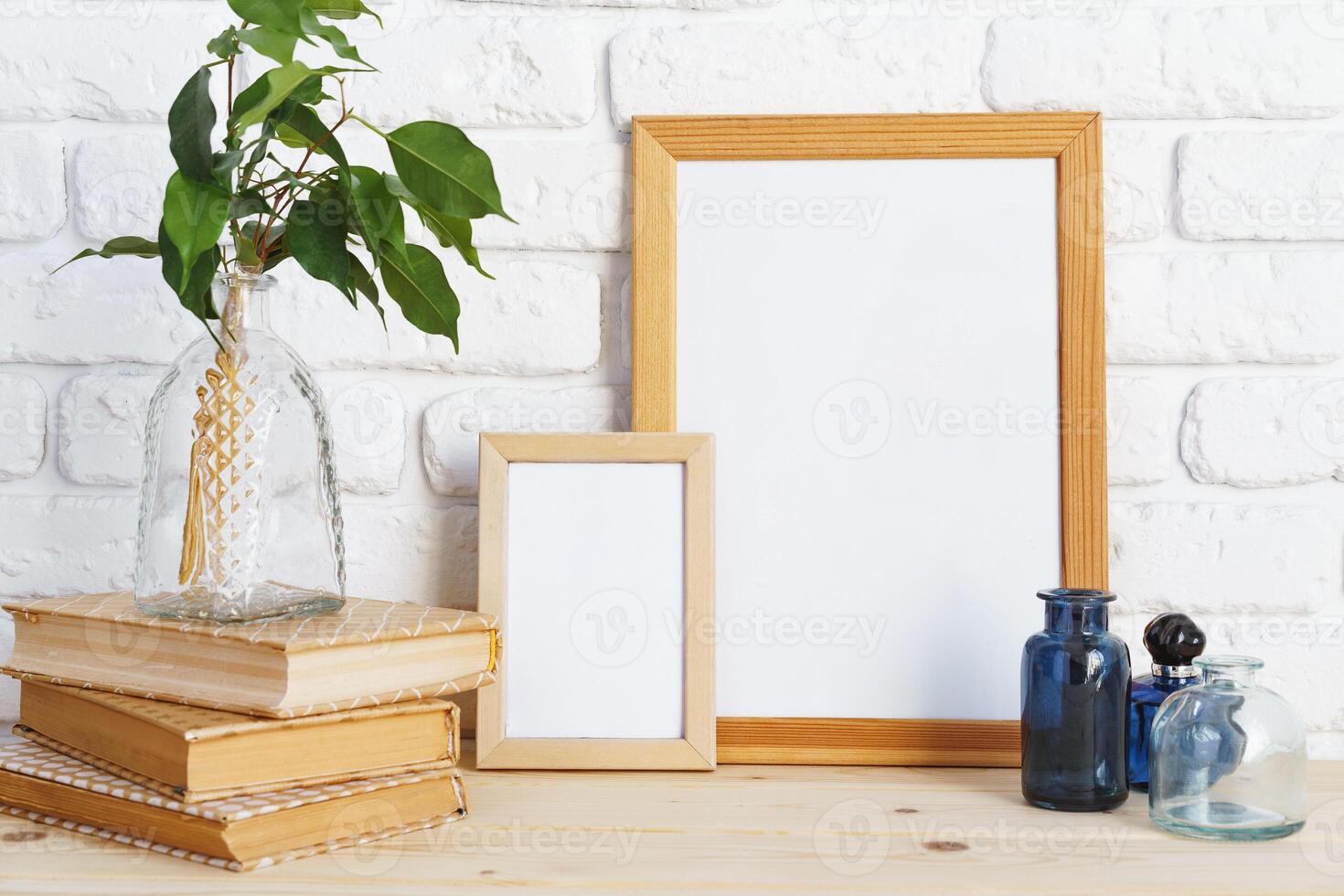 Wooden frame mockup on table with modern vase and books photo