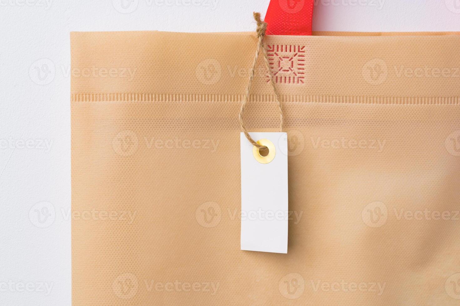 Blank paper tag with shopper paperbag on white background photo