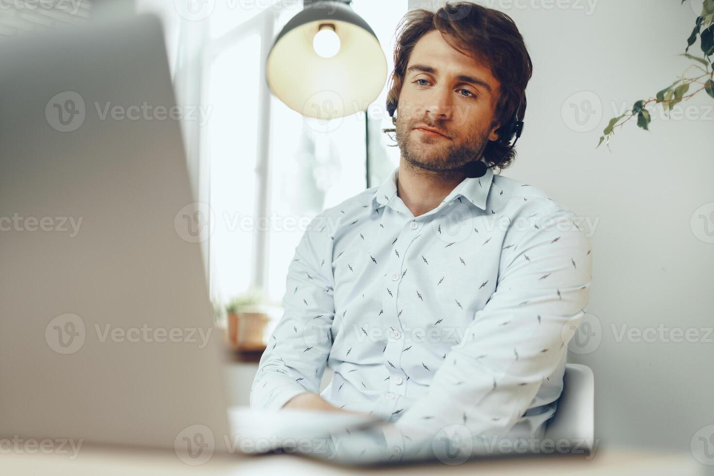 Young caucasian businessman holding call with clients partners photo