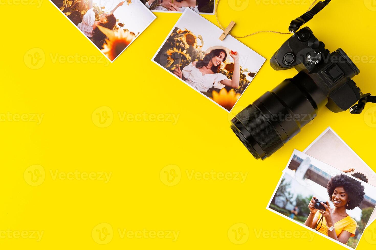 Photo camera with colorful printer photos on yellow background