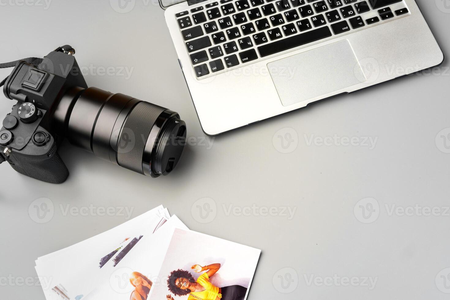 Laptop and camera on the table close up. Printing photos