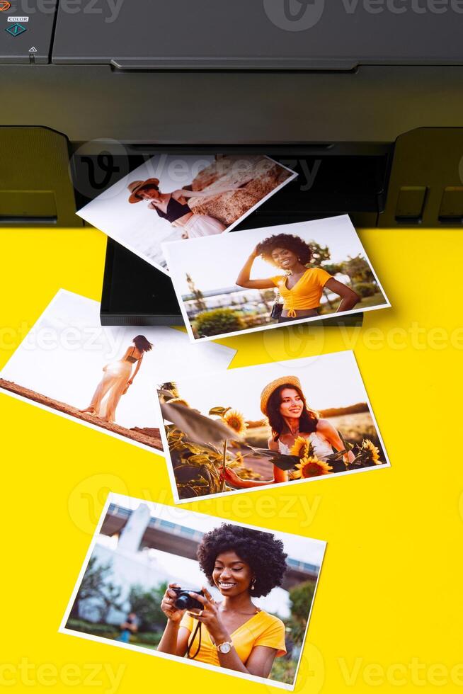Printer printing colorful photos of people close up, yellow background