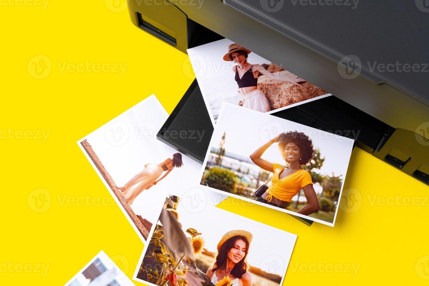 Printer printing colorful photos of people close up, yellow background