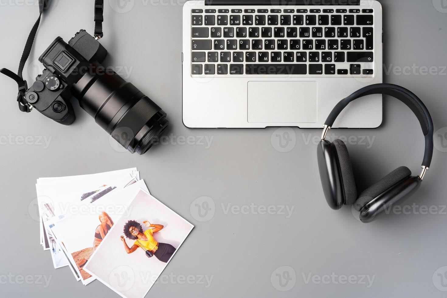 Laptop and camera on the table close up. Printing photos