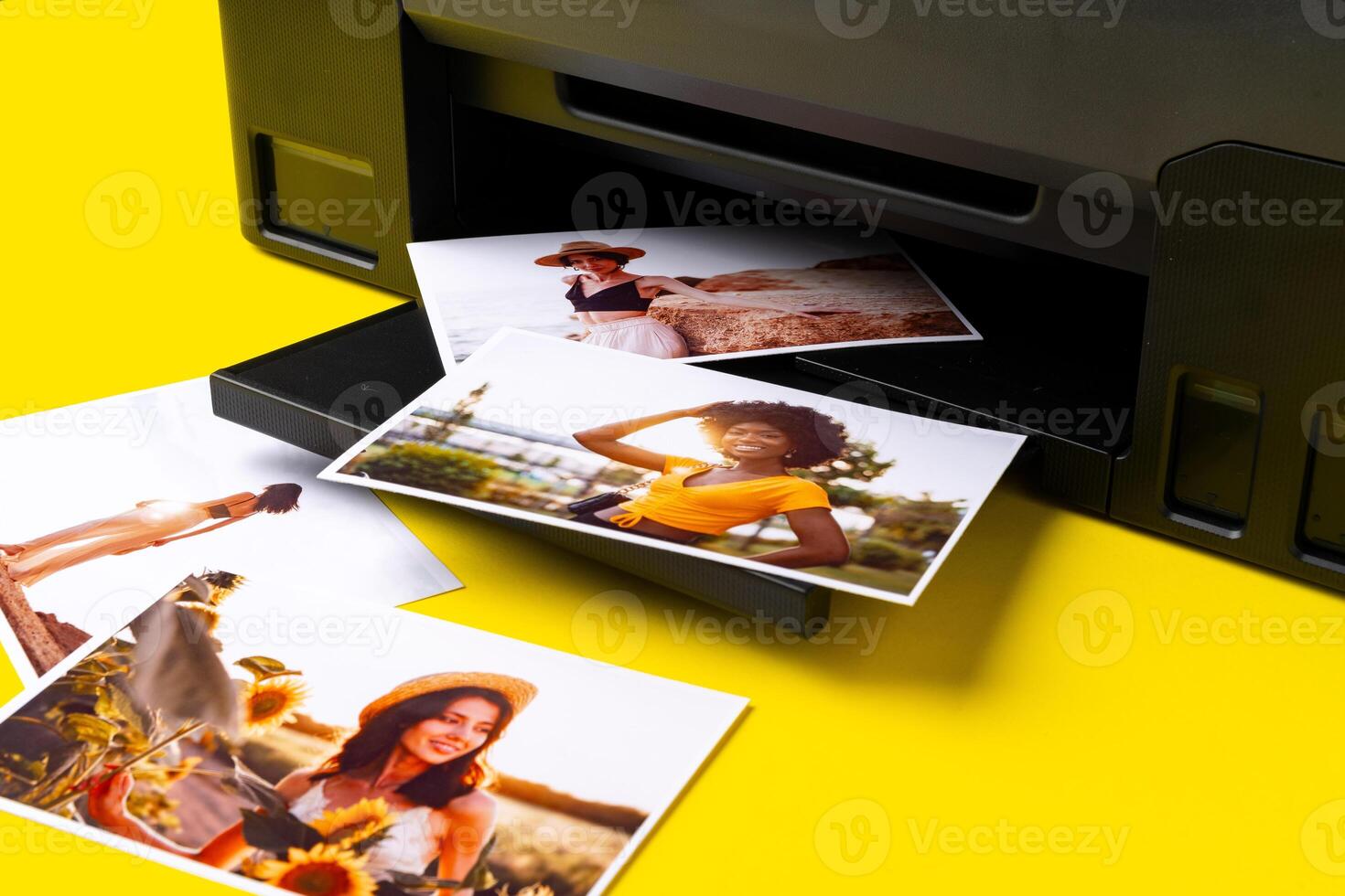 Printer printing colorful photos of people close up, yellow background