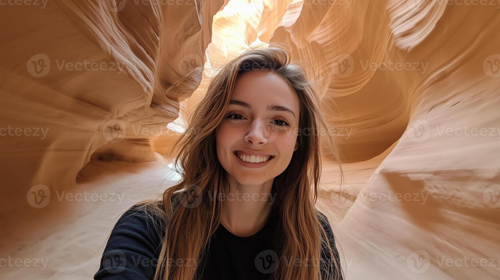 Smiling young woman explores the stunning beauty of Antelope Canyon in Arizona during a bright sunny day photo
