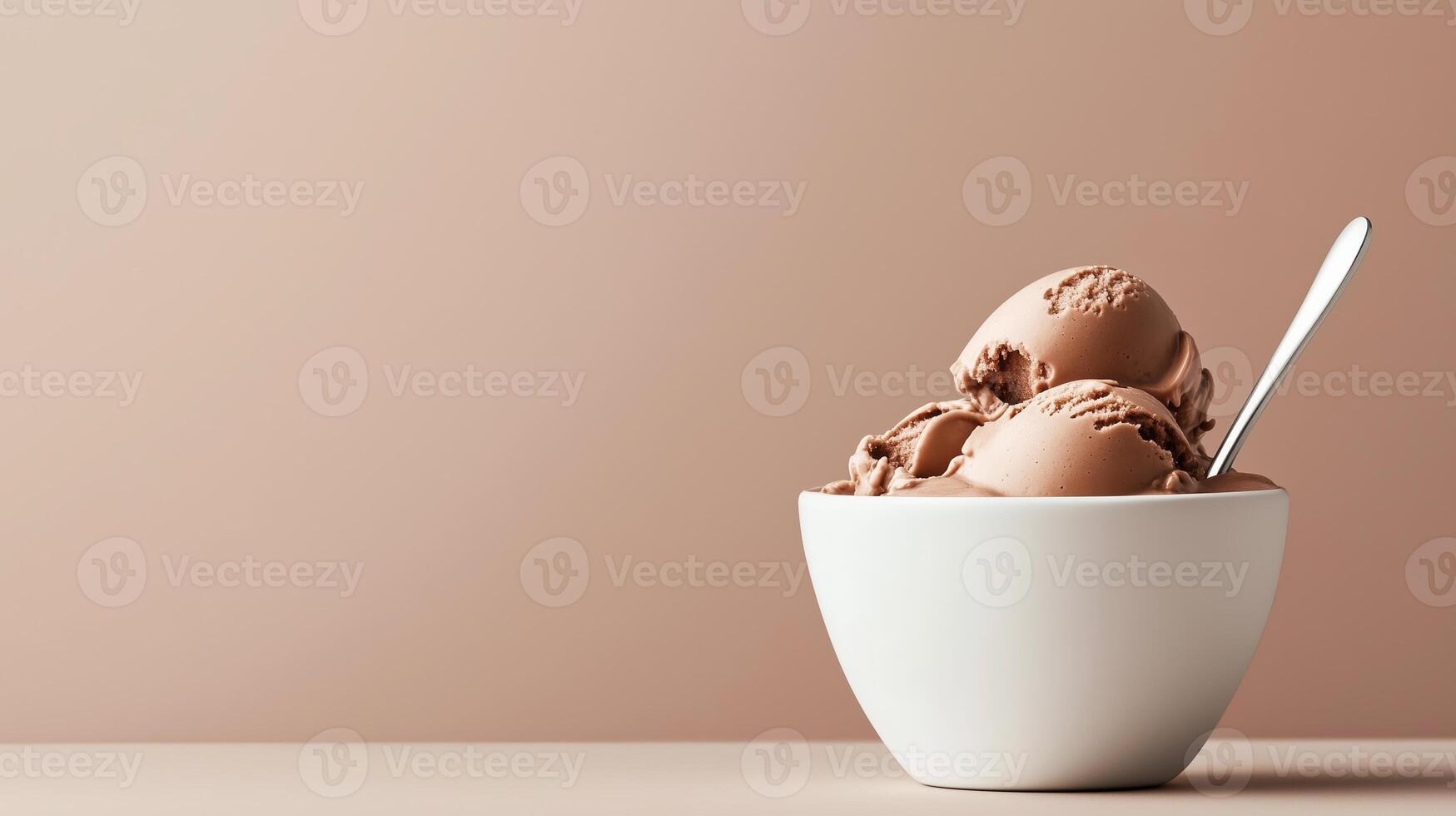 Chocolate ice cream served in a simple white bowl against a soft beige background photo