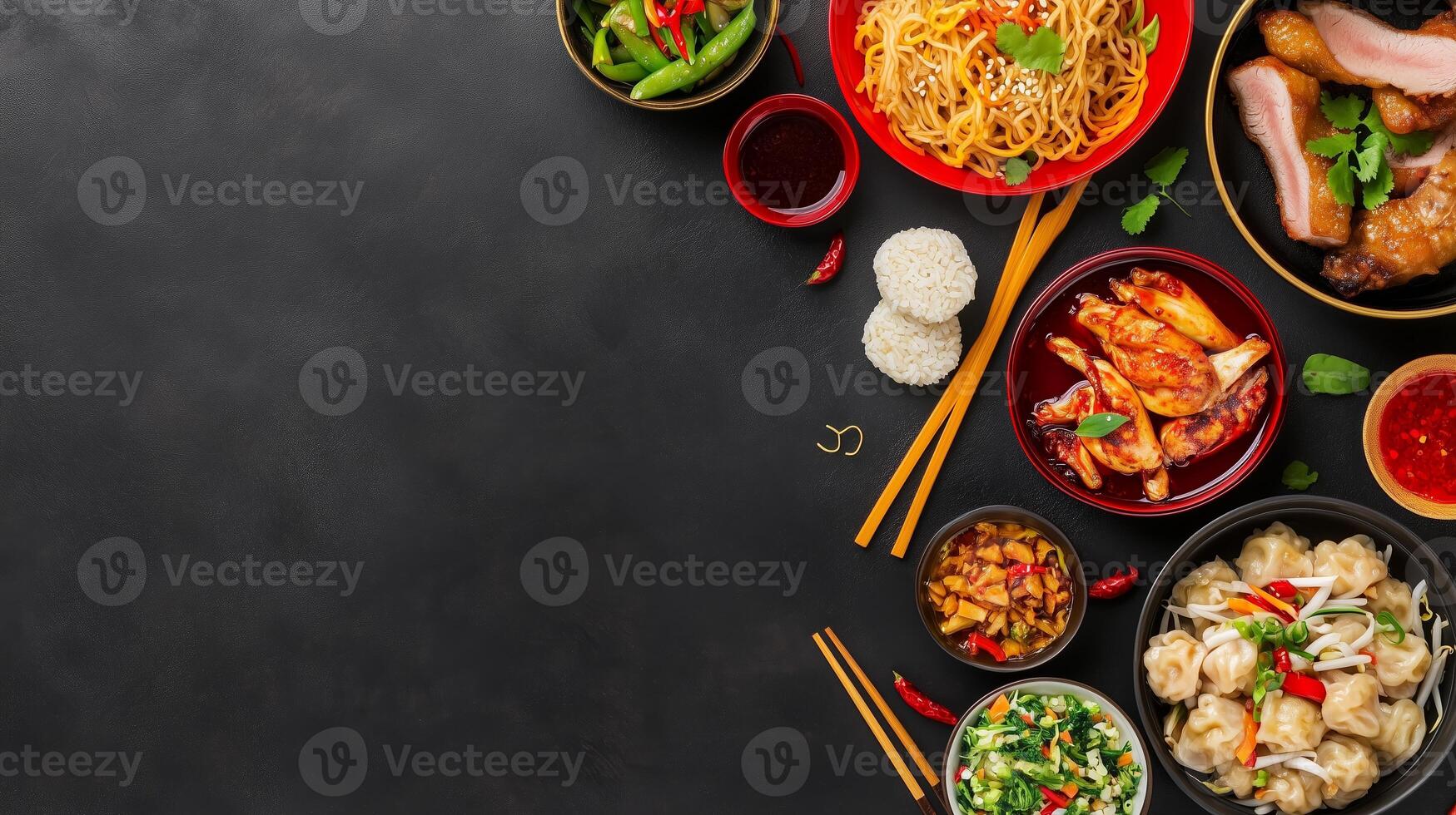 Colorful assortment of Asian dishes served on a dark table with chopsticks and sauces photo