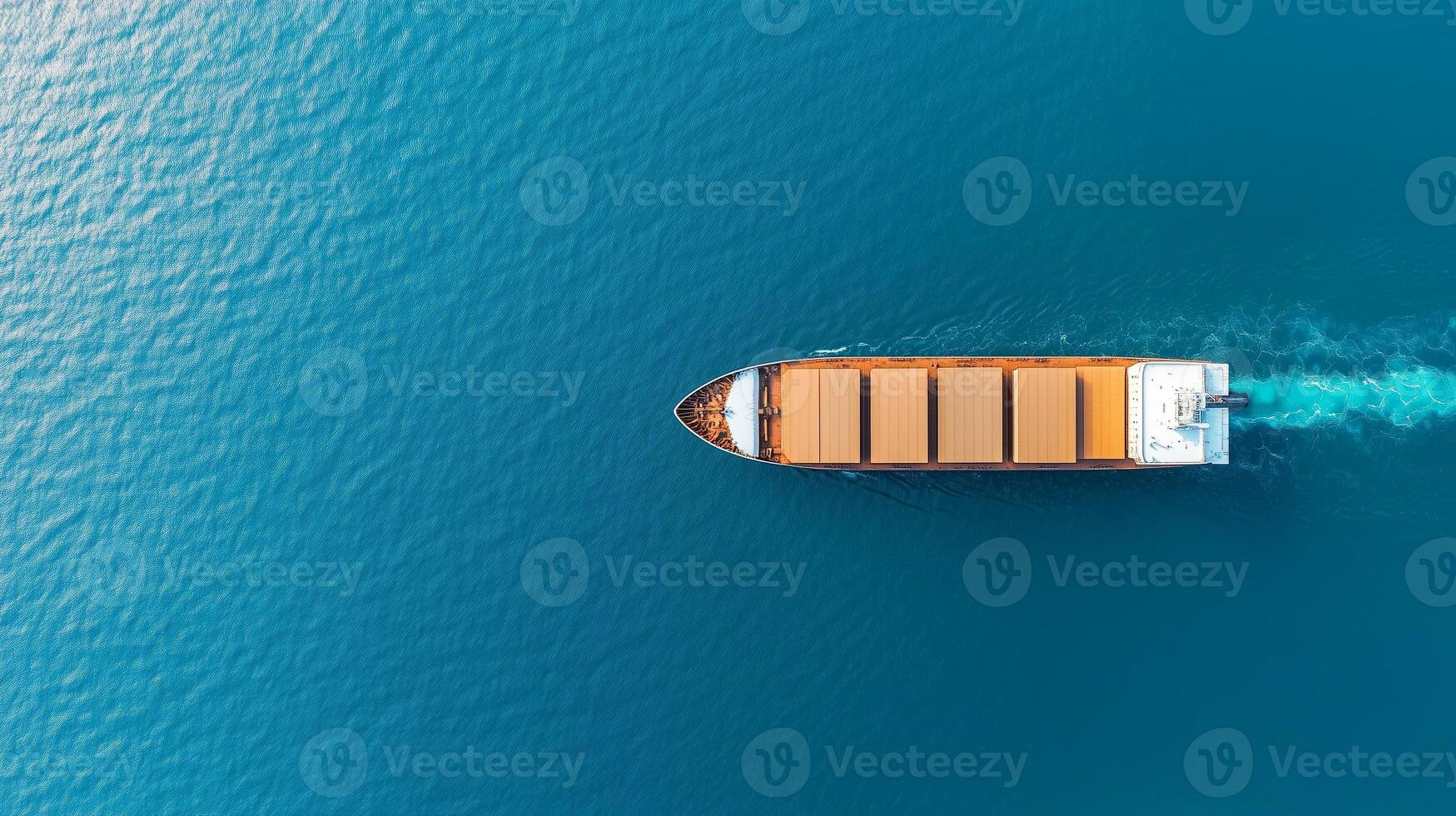 Cargo ship navigates calm waters under bright blue sky during daytime in expansive ocean photo