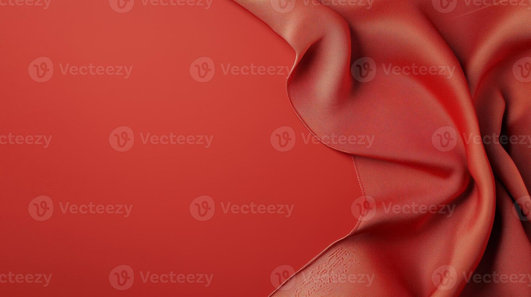 Textured red fabric with soft draping showcasing rich color and smooth surface photo