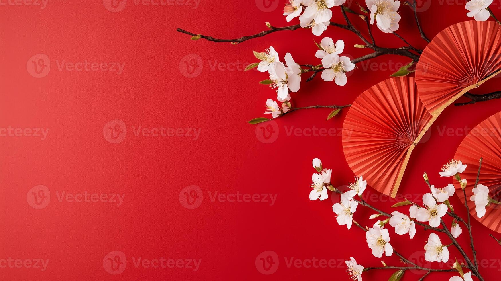Decorated red background with cherry blossom branches and folding fans for a festive celebration in spring photo