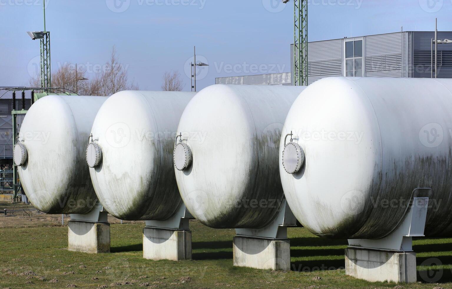 Four industrial gas tanks in a row photo