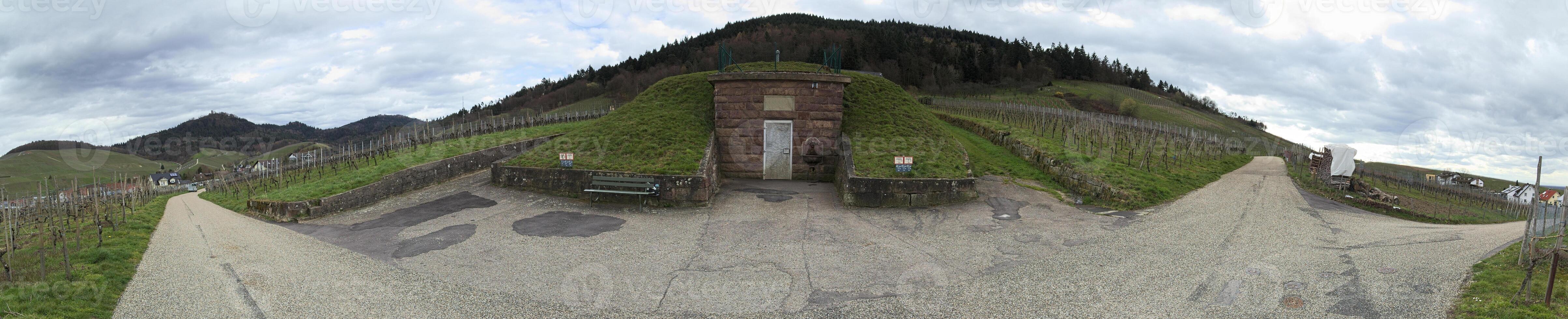 Panoramic view of road junction with a historical drinking water facility in Neuweier, Baden-Wurttemberg, Germany photo