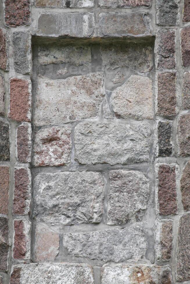 Stone wall with slot to insert e.g. a plate photo