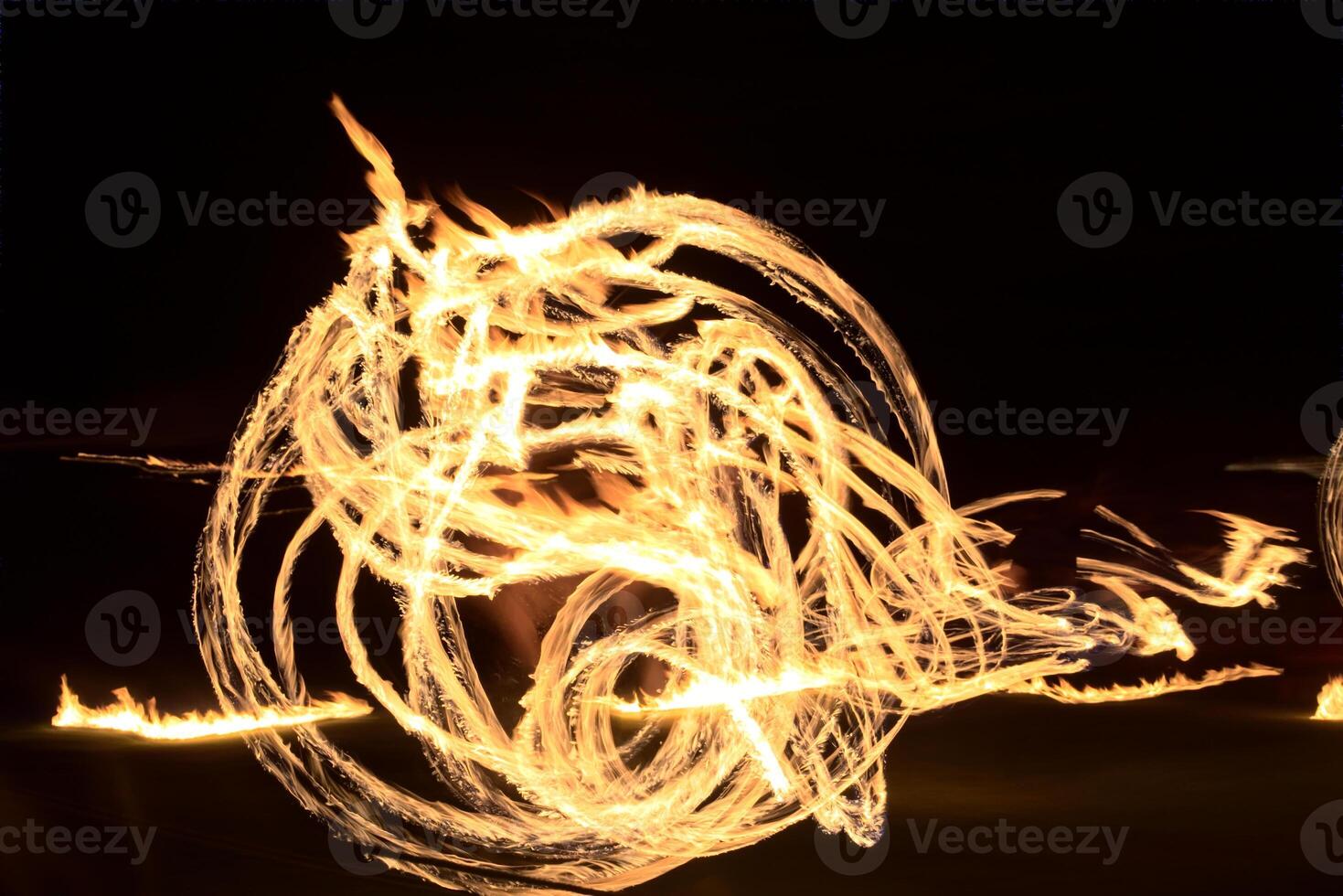 Long exposure shot of moving burning torches and fire photo