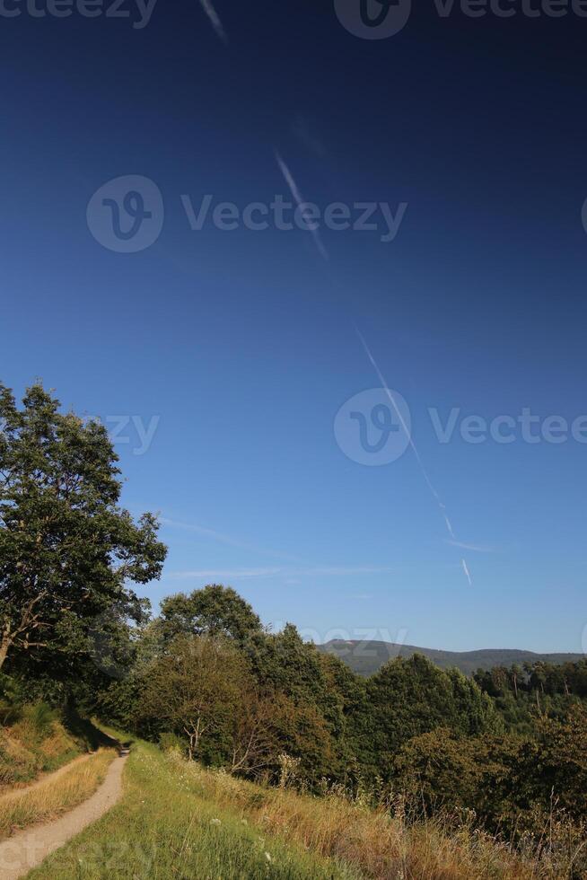 Beautiful landscape in Baden-Wurttemberg with diagonal vapor trail on blue sky photo
