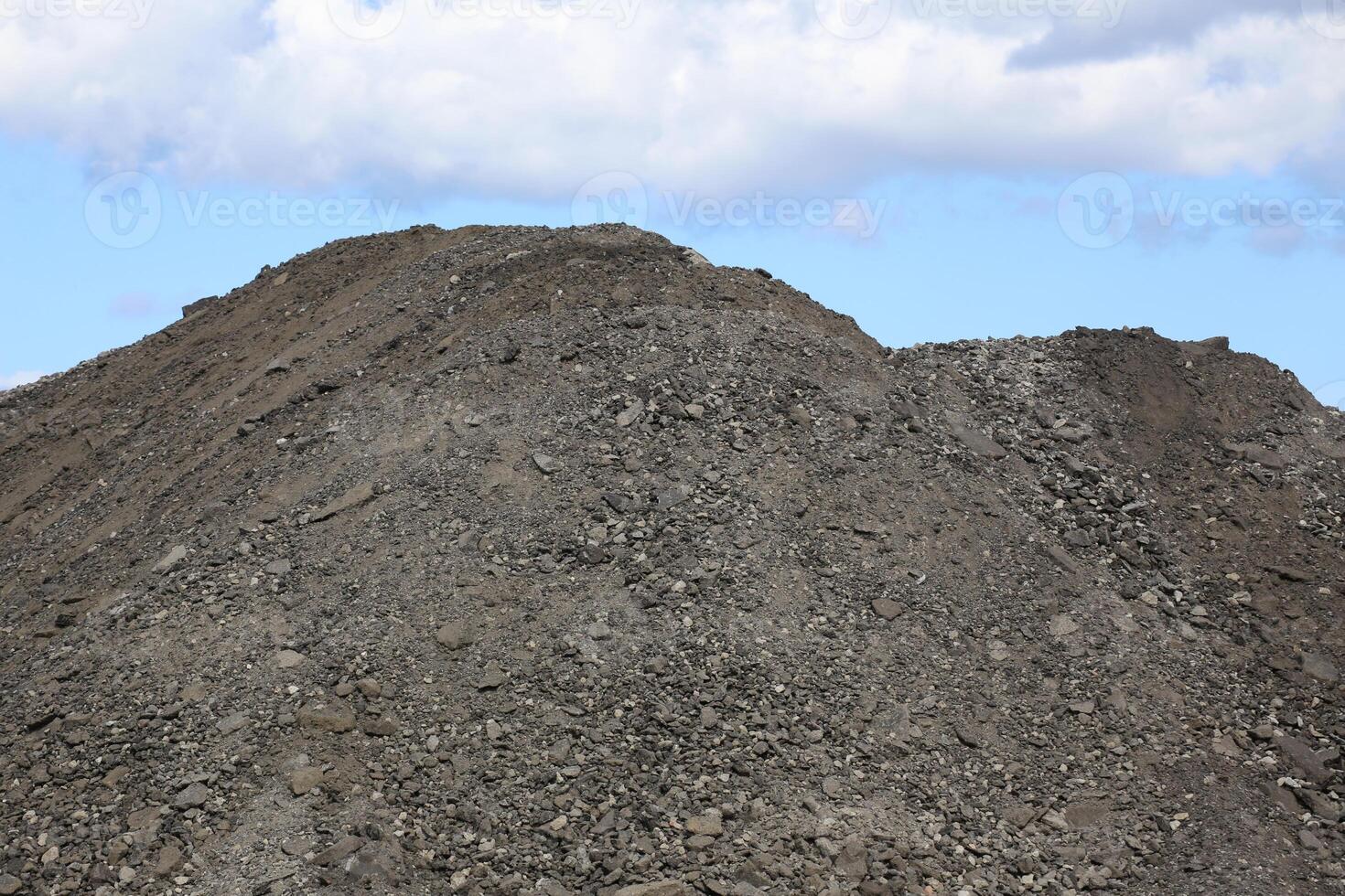 Heap of gravel in front of sky photo