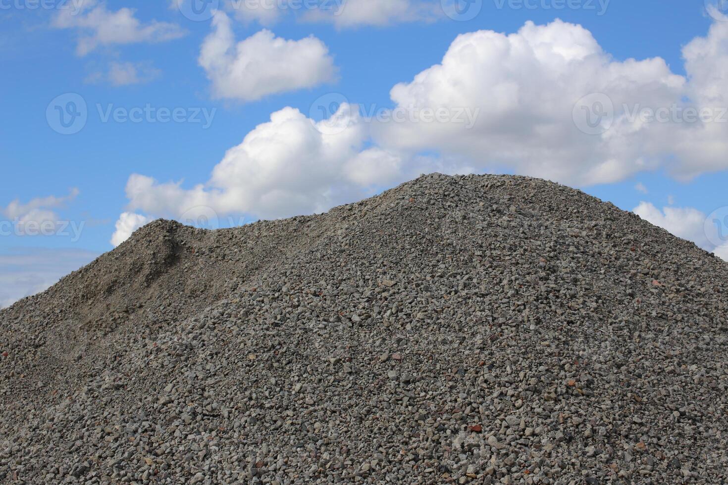 Heap of gravel in front of sky photo
