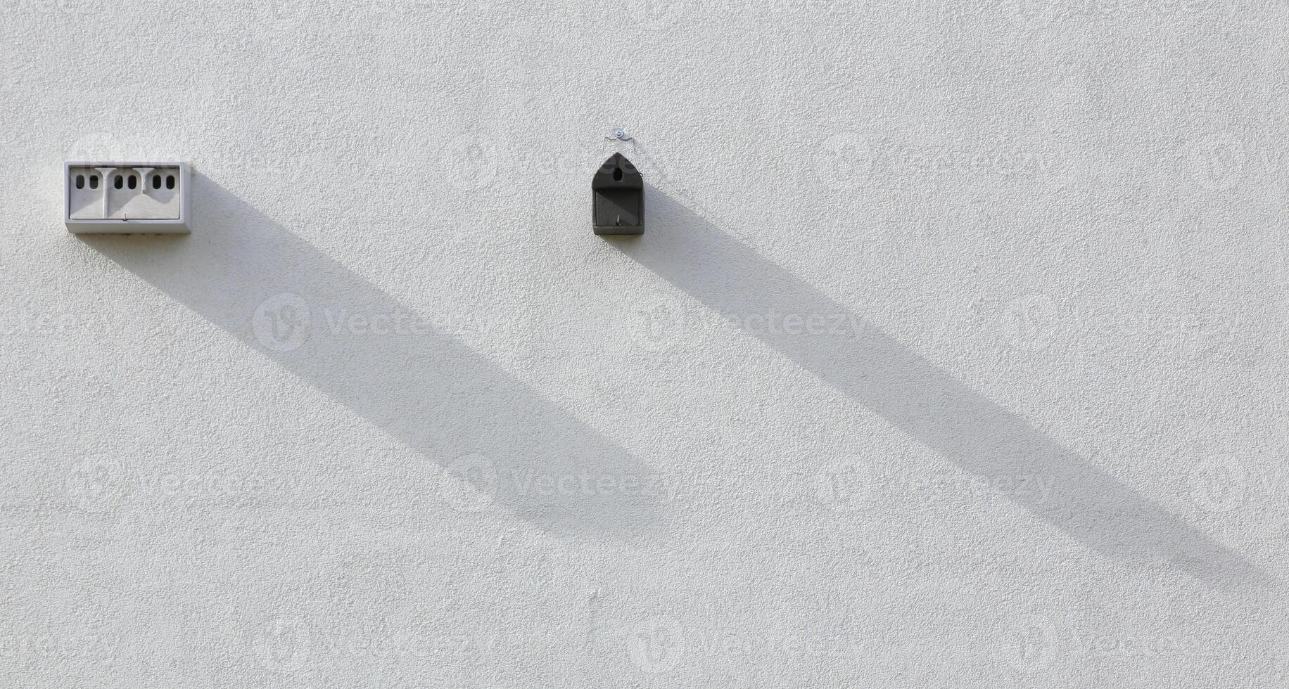 Different nest boxes installed on a house wall photo