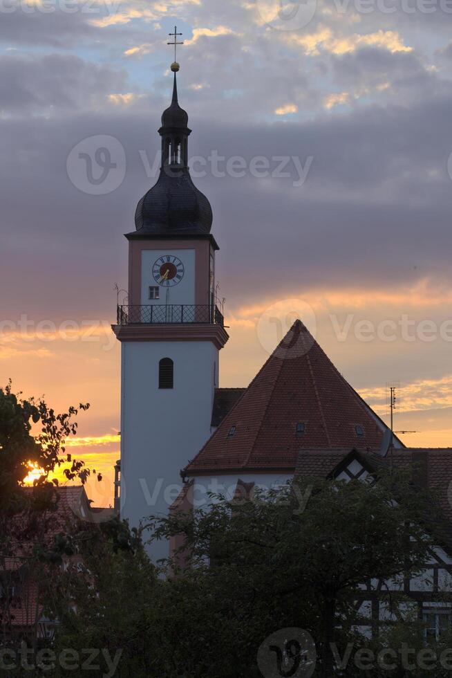 Catholic parish church St. Johann Baptist in Hilpoltstein, Germany in evening light photo