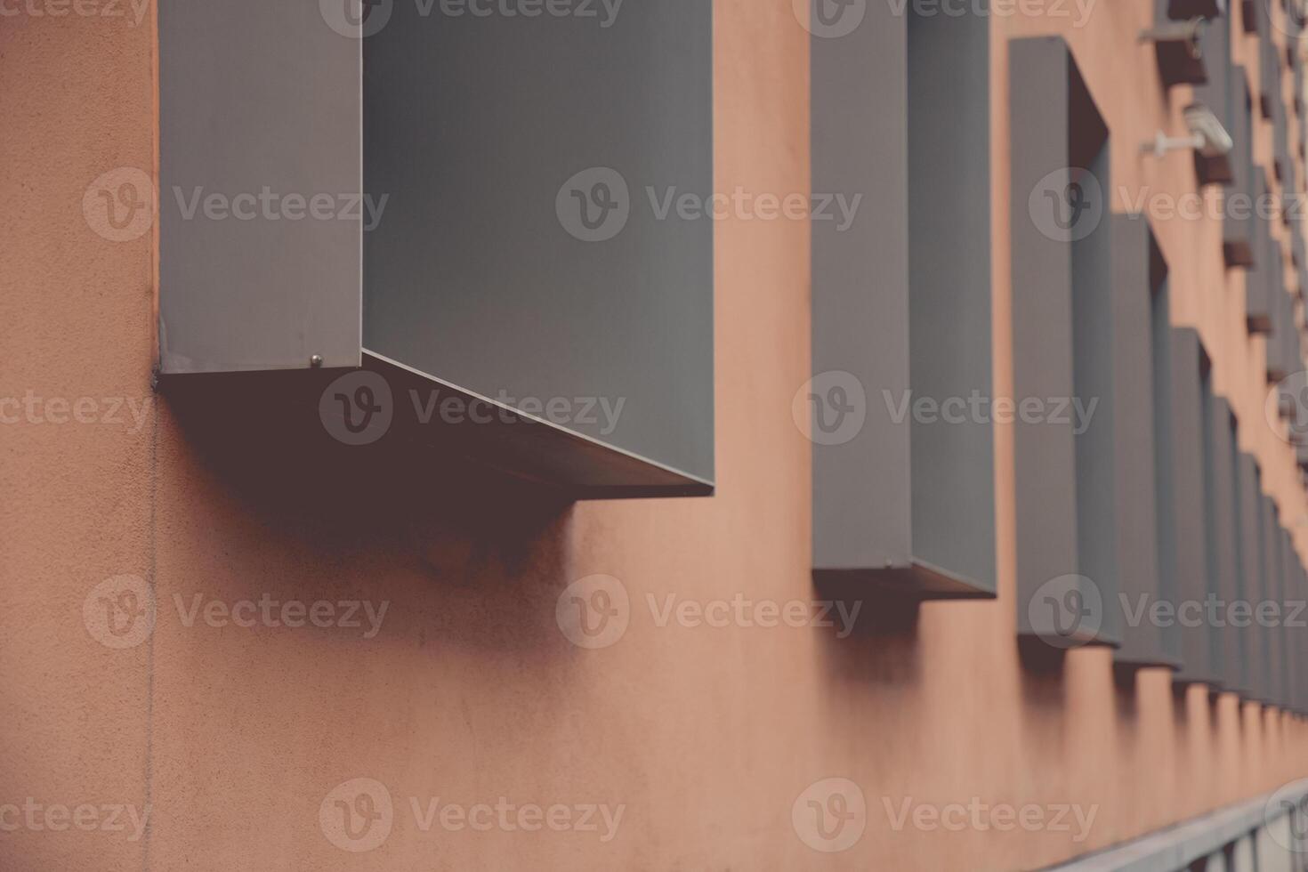 Geometric urban structure of pale brown wall and rows of metal framed windows in dimensional perspective. Modern architecture of Berlin Germany. Details of building exterior photo