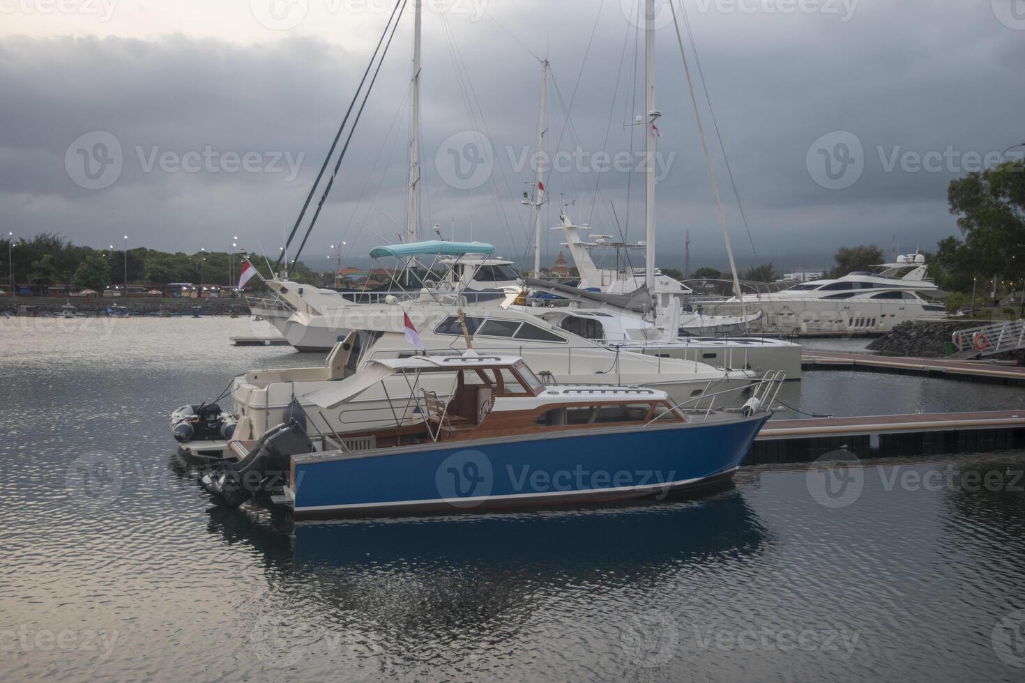 Boats anchored at the pier in the cloudy afternoon. photo
