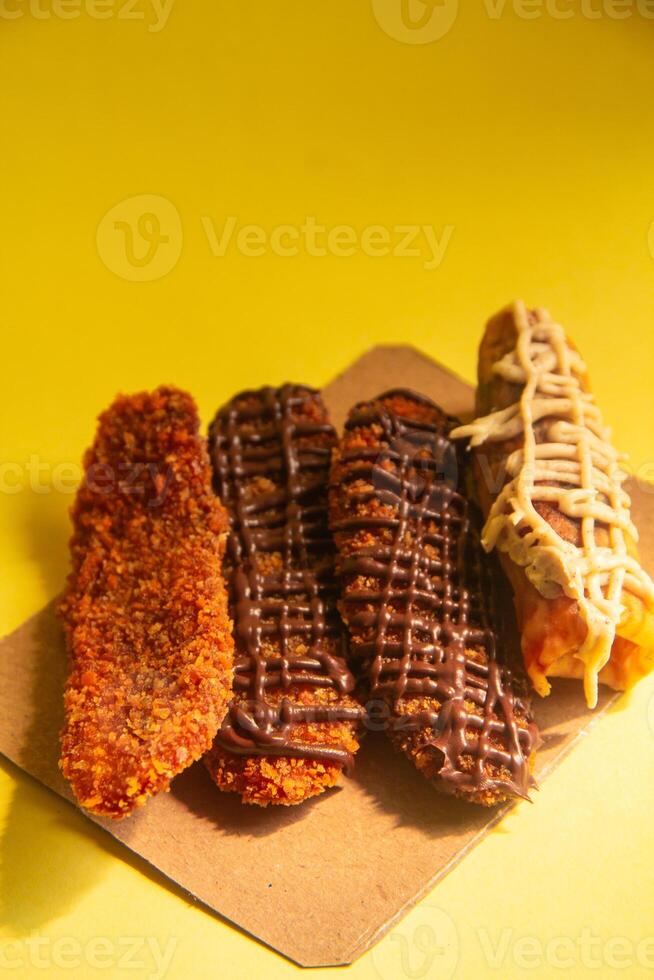 Crispy banana cake, sweet banana cake with sweet topping on a yellow background photo