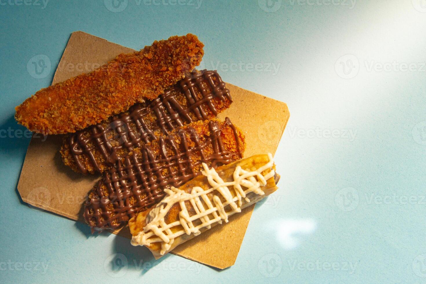 Crispy banana cake, sweet banana cake with sweet topping on a blue background photo