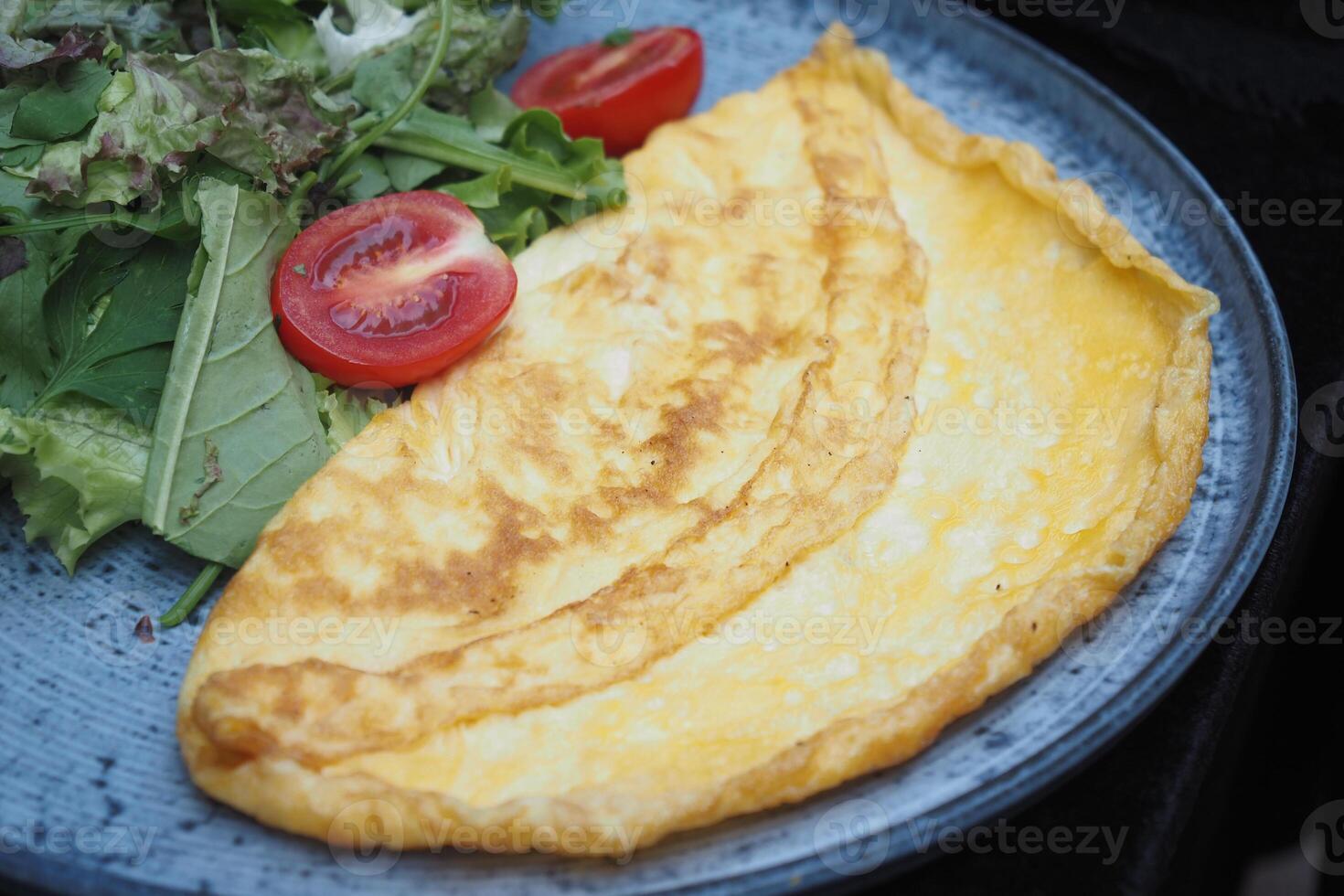 A Delicious Golden Omelette Beautifully Served on a Plate, Perfectly Ready to Be Enjoyed photo