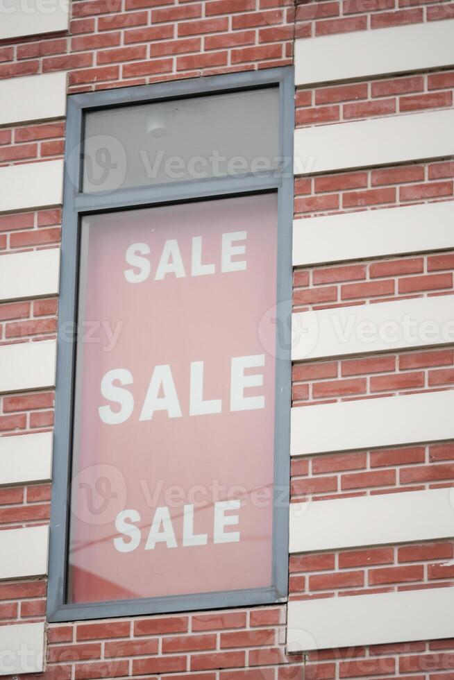 A Bright and EyeCatching Sale Sign Positioned in the Retail Window photo