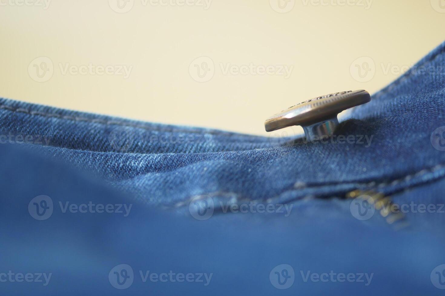 A Detailed CloseUp View of a Button and Zipper on Denim Jeans photo