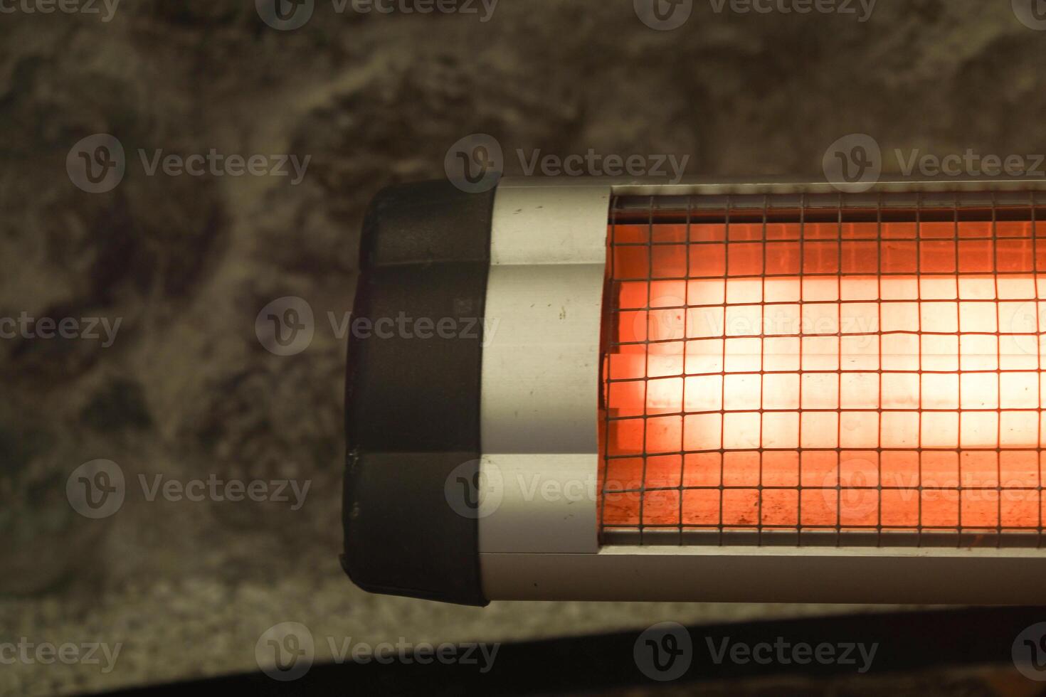 Modern electric infrared heater in living room, closeup photo