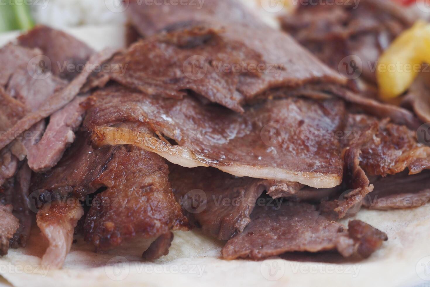 Enjoying Delicious Slices of Juicy Grilled Meat Served on Tortilla photo