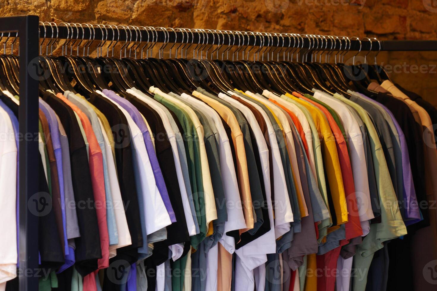 A Diverse Array of Colorful TShirts Neatly Hanging on a Rack for Display photo