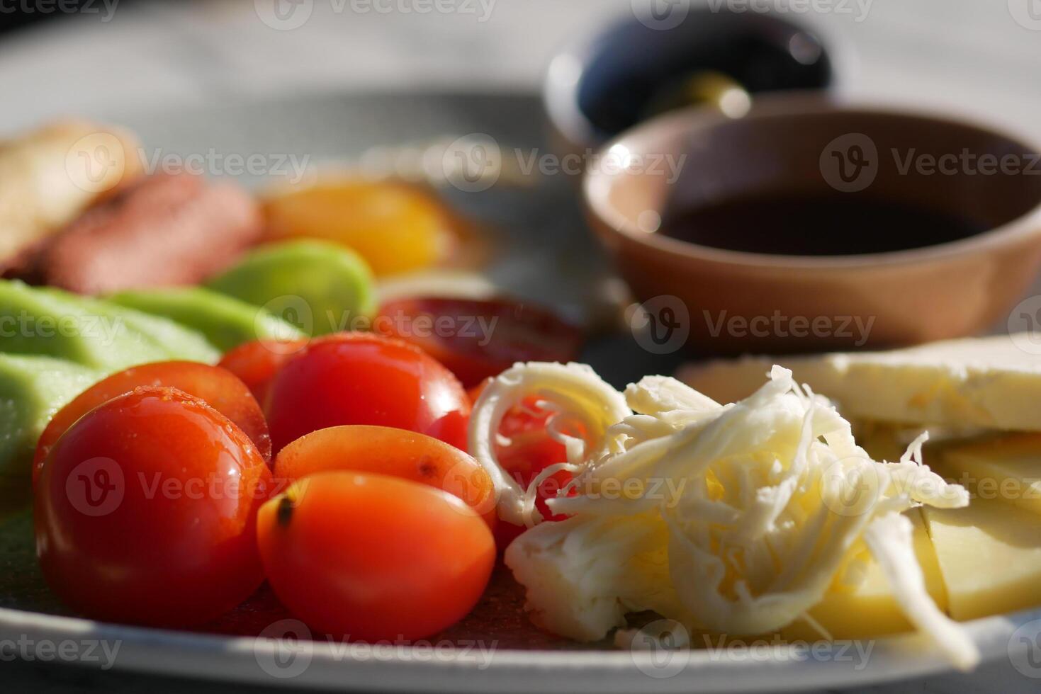 Fresh Mediterranean Platter with Tomatoes, Cheese, and Olives photo