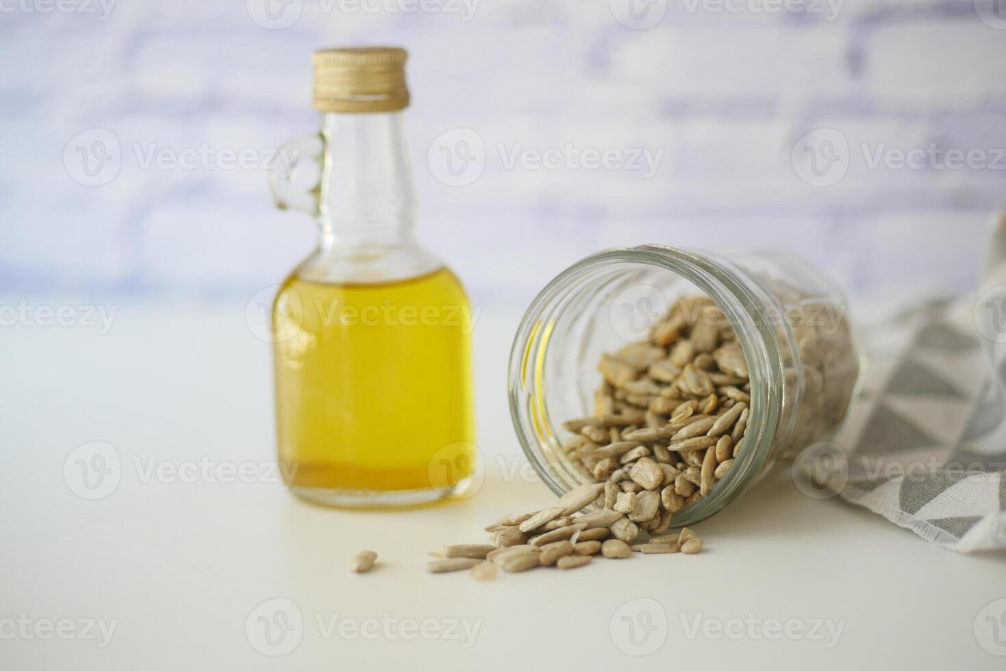 Sunflower Seeds and Oil Stored in Elegant Glass Containers for Freshness photo