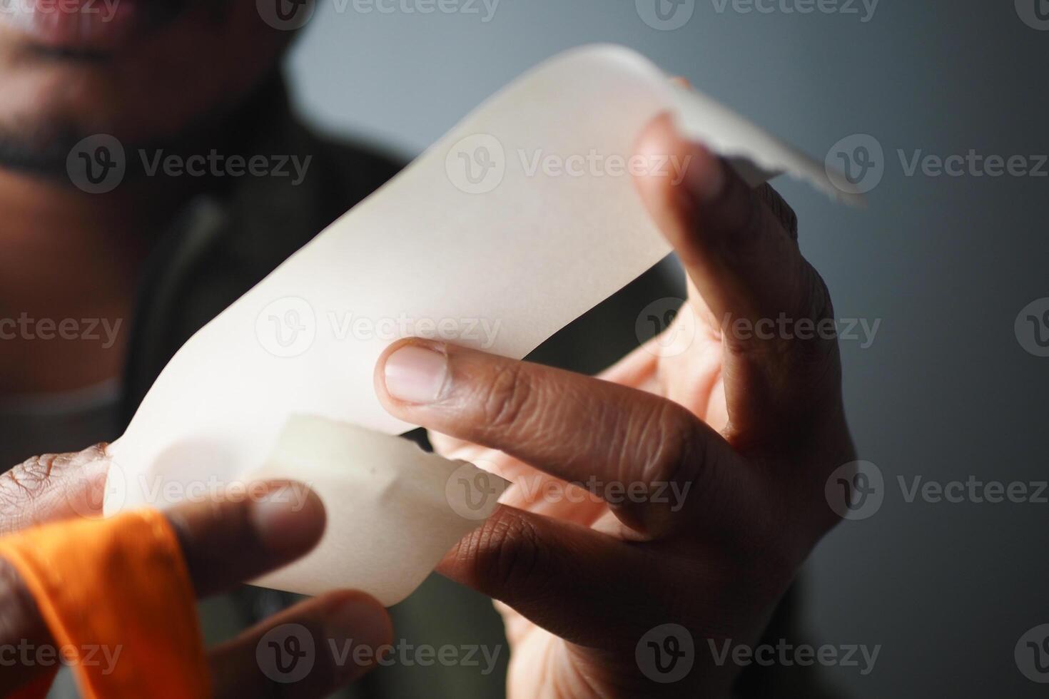 Close-Up of Hands Holding Receipt and Grocery Packet photo